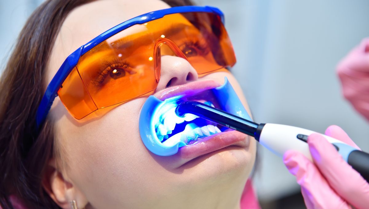 Odontólogo usando tecnología láser con un paciente (Fuente: Canva)