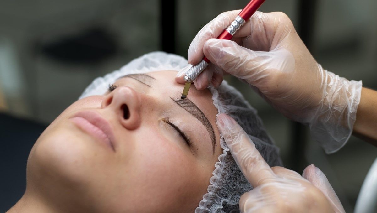 Esteticista realizando microblading en las cejas de una mujer (Foto. Freepik)