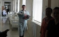 Un sanitario lleva a un bebé recién nacido en brazos en un hospital que se encuentra bajo ley marcial tras la invasión de Rusia, a ocho de marzo de 2022, en Kiev. (Foto. Ukrinform dpa Ukrinform)