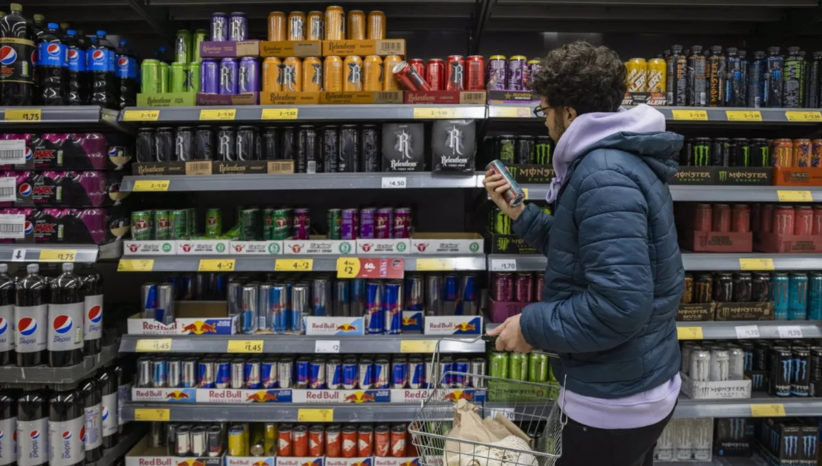 Menor de edad frente a diferentes bebidas energéticas en el supermercado. (EP)